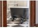 Close-up of a classic black clawfoot tub set on checkerboard tile flooring at 1475 N Humboldt St # 22, Denver, CO 80218