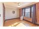 Bright bedroom features exposed brick, hardwood floors, updated ceiling fan, and large window at 1475 N Humboldt St # 22, Denver, CO 80218