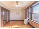 Bright bedroom features exposed brick, hardwood floors, updated ceiling fan, and a view at 1475 N Humboldt St # 22, Denver, CO 80218