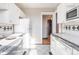 Bright kitchen with white cabinets, an electric range, and black and white tiled accents at 1475 N Humboldt St # 22, Denver, CO 80218