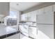 Bright kitchen with white cabinets and black and white tiled backsplash and counters at 1475 N Humboldt St # 22, Denver, CO 80218