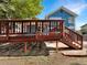 A lovely home with a wooden backyard deck and stairs leading down to a patio area at 5005 W 128Th Pl, Broomfield, CO 80020