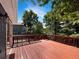 A large wooden deck in the backyard is surrounded by mature trees at 5005 W 128Th Pl, Broomfield, CO 80020