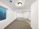 Spacious basement with textured ceiling, window, and neutral carpet, offering potential for customization at 5005 W 128Th Pl, Broomfield, CO 80020