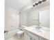 Bright, all-white bathroom featuring a tub-shower combo, large mirror, and clean finishes at 5005 W 128Th Pl, Broomfield, CO 80020