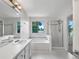 A spacious bathroom with shower, soaking tub, double vanity, and decorative floor tile at 5005 W 128Th Pl, Broomfield, CO 80020