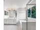 Bright bathroom with double vanity, soaking tub, and glass-enclosed shower at 5005 W 128Th Pl, Broomfield, CO 80020