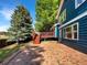 The exterior of this home features a brick patio and wooden deck in the backyard at 5005 W 128Th Pl, Broomfield, CO 80020