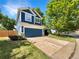 Charming two-story home with a well-maintained lawn and a deep blue two car garage at 5005 W 128Th Pl, Broomfield, CO 80020