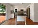 Modern kitchen with white cabinets, stainless steel appliances, and access to the backyard deck at 5005 W 128Th Pl, Broomfield, CO 80020