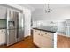 Modern kitchen with stainless steel appliances, an island, and a view of the open floorplan at 5005 W 128Th Pl, Broomfield, CO 80020