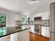 Modern kitchen with white cabinetry, stainless steel appliances, and an island with seating at 5005 W 128Th Pl, Broomfield, CO 80020
