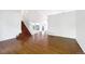 Spacious living room boasts gleaming hardwood floors and staircase at 5005 W 128Th Pl, Broomfield, CO 80020