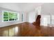 A bright living room with hardwood floors, a large window, and a staircase at 5005 W 128Th Pl, Broomfield, CO 80020
