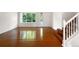 Bright living room boasts gleaming hardwood floors and a large window, offering a welcoming space at 5005 W 128Th Pl, Broomfield, CO 80020