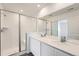 Bathroom featuring a double vanity, large mirror, and a glass-enclosed shower at 15267 Fillmore St, Thornton, CO 80602