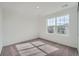 Light-filled bedroom featuring a large window and neutral carpeting at 15267 Fillmore St, Thornton, CO 80602