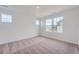 Well-lit bedroom with a large window and plush carpet at 15267 Fillmore St, Thornton, CO 80602