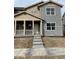 Charming two-story home with a covered porch and neutral-colored siding at 15267 Fillmore St, Thornton, CO 80602