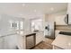 Modern kitchen features stainless appliances, quartz counters and an island with a sink at 15267 Fillmore St, Thornton, CO 80602