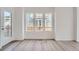 Bright living space with wood-look floors and a door to the exterior at 15267 Fillmore St, Thornton, CO 80602