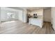 Open-concept living space with wood-look floors and a modern kitchen at 15267 Fillmore St, Thornton, CO 80602