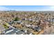 Wide aerial shot showing the house in its urban setting, with a distant view of the city skyline at 4563 W 34Th Ave, Denver, CO 80212