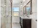 Bright bathroom featuring dual sinks, modern fixtures, and a glass-enclosed shower at 4563 W 34Th Ave, Denver, CO 80212