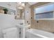 Cozy bathroom with white pedestal sink, tub, and neutral tiling at 4563 W 34Th Ave, Denver, CO 80212