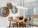 Bright dining area with a wooden table, stylish chairs, and a modern light fixture at 4563 W 34Th Ave, Denver, CO 80212