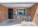 Inviting front porch featuring a table, chairs, and beautiful brick accents, perfect for relaxing at 4563 W 34Th Ave, Denver, CO 80212