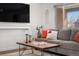 Comfortable gray couch, modern decor, and a large flat-screen television in a cozy living room at 4563 W 34Th Ave, Denver, CO 80212