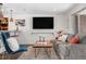 Cozy living room featuring a comfortable gray couch, modern decor, and a large flat-screen television at 4563 W 34Th Ave, Denver, CO 80212