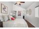 Bright bedroom with vaulted ceilings, a comfortable bed with accent pillows, and access to a ensuite bathroom at 4563 W 34Th Ave, Denver, CO 80212