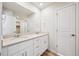 Bright bathroom featuring a double sink vanity with white cabinets and a large mirror at 1417 Bloom St, Brighton, CO 80601