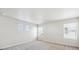 Bright bedroom with carpeting, three windows, white walls, and baseboard trim at 1417 Bloom St, Brighton, CO 80601