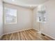 Bright bedroom featuring wood-look flooring, white walls and large windows at 1417 Bloom St, Brighton, CO 80601