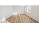 Bright bedroom with wood-look flooring, white walls and large windows at 1417 Bloom St, Brighton, CO 80601