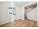 Bright room with wood-look flooring, white walls and large windows near the staircase at 1417 Bloom St, Brighton, CO 80601