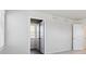 A closet with white paneled bi-fold doors is next to a room with two white paned windows at 1417 Bloom St, Brighton, CO 80601