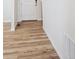 Bright entryway featuring durable wood-look flooring, a white door and white walls at 1417 Bloom St, Brighton, CO 80601