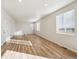 Spacious living room with wood-look flooring, white walls and large windows at 1417 Bloom St, Brighton, CO 80601