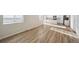 Open-concept living area featuring wood-look floors and a kitchen with an island at 1417 Bloom St, Brighton, CO 80601