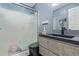 Bathroom features a modern black sink and gray vanity with a sliding glass shower at 7925 York St # 2, Denver, CO 80229