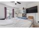 Bright bedroom with a large bed, ceiling fan, and large window overlooking deck at 7925 York St # 2, Denver, CO 80229