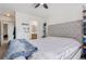 Bright bedroom with a large bed, ceiling fan, and access to the bathroom at 7925 York St # 2, Denver, CO 80229