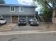 A two-story exterior of an apartment complex with parking and a stairwell entrance at 7925 York St # 2, Denver, CO 80229