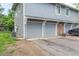 Attached two car garage with gray doors and well-maintained landscaping at 7925 York St # 2, Denver, CO 80229