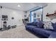 Spacious living room area with comfortable blue sectional, office space and workout area at 7925 York St # 2, Denver, CO 80229