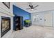 Open concept living room features a fireplace, an aquarium, and light gray carpet at 7925 York St # 2, Denver, CO 80229